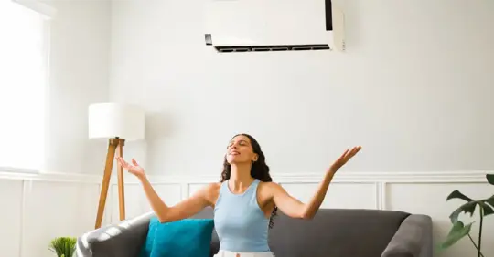 Woman feeling the clean air inside her home.